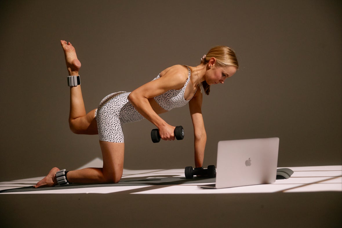 Online training setup from the SDP photoshoot, with a laptop and workout equipment.