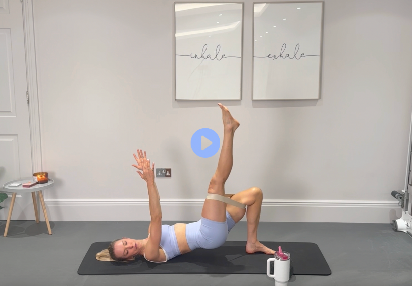 Loop & Lift: light-blue workout set, lying on the mat with one leg lifted and a mini loop.