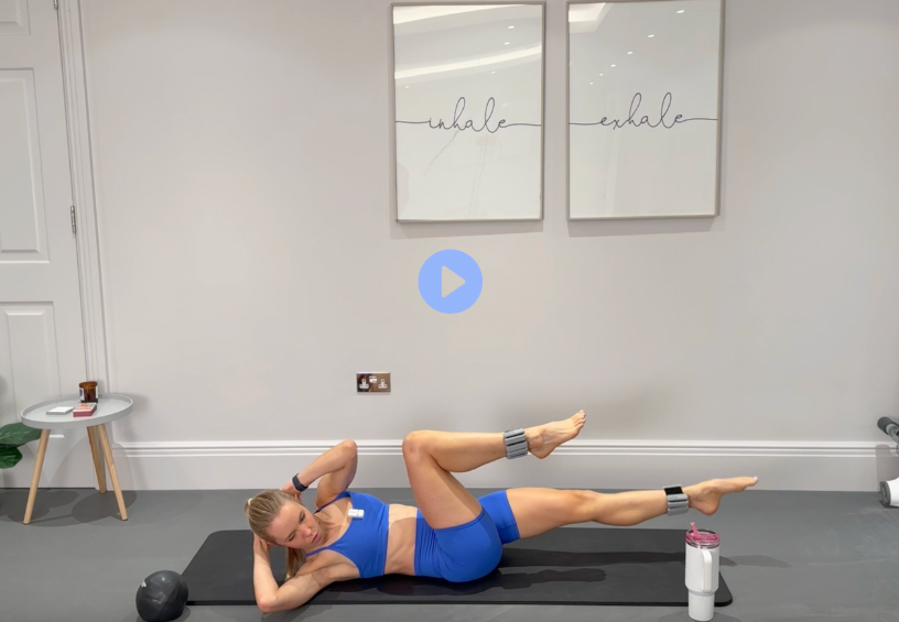 Full Body Burn: bright-blue workout set, performing a bicycle-style core movement on the mat.