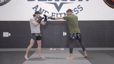 Fighter blocking a jab while another fighter throws a jab