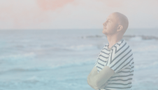 a man taking a deep breath near the ocean.
