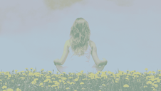 a woman meditating in the lotus position in a field of flowers.
