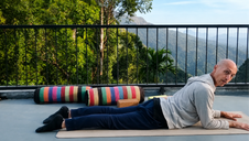 Michael practicing yoga outdoors with a peaceful mountain view