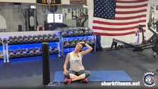 Shark Fitness instructor Jen demonstrating deep flexibility stretches during a bonus recovery class.