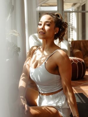 Ashley sitting in white outfit