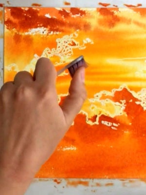 Using brushwork and wet-in-wet techniques to create glowing skies