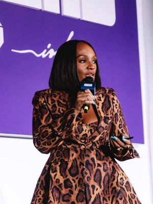 Ashley Fox speaking into a microphone on the Creative Business Stage during Investing 101 at CultureCon 2026