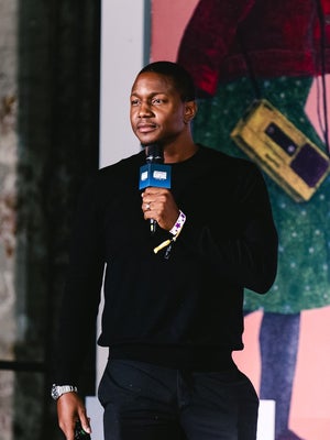Andrew Coombs speaking into a microphone during Let's Talk Taxes at CultureCon 2026