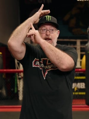 Coach K demonstrates how to throw a Muay Thai elbow