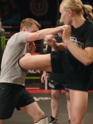 Girl fighter kicks guy in the body