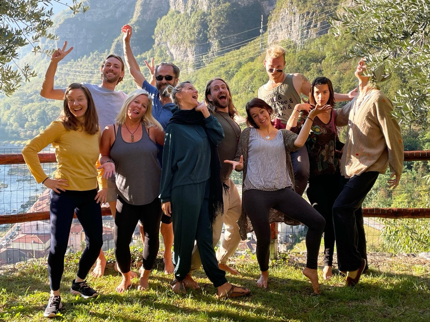 The group posing playfully outdoors with mountains behind them