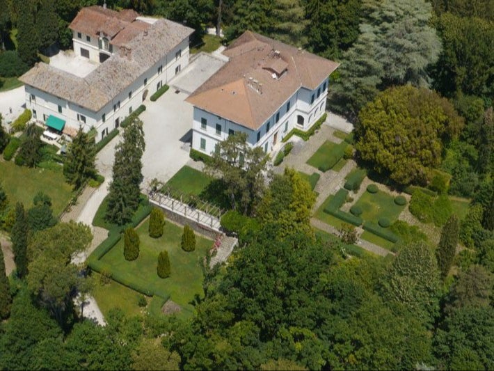 Aerial view of Villa Fassia and its gardens, surrounded by woods