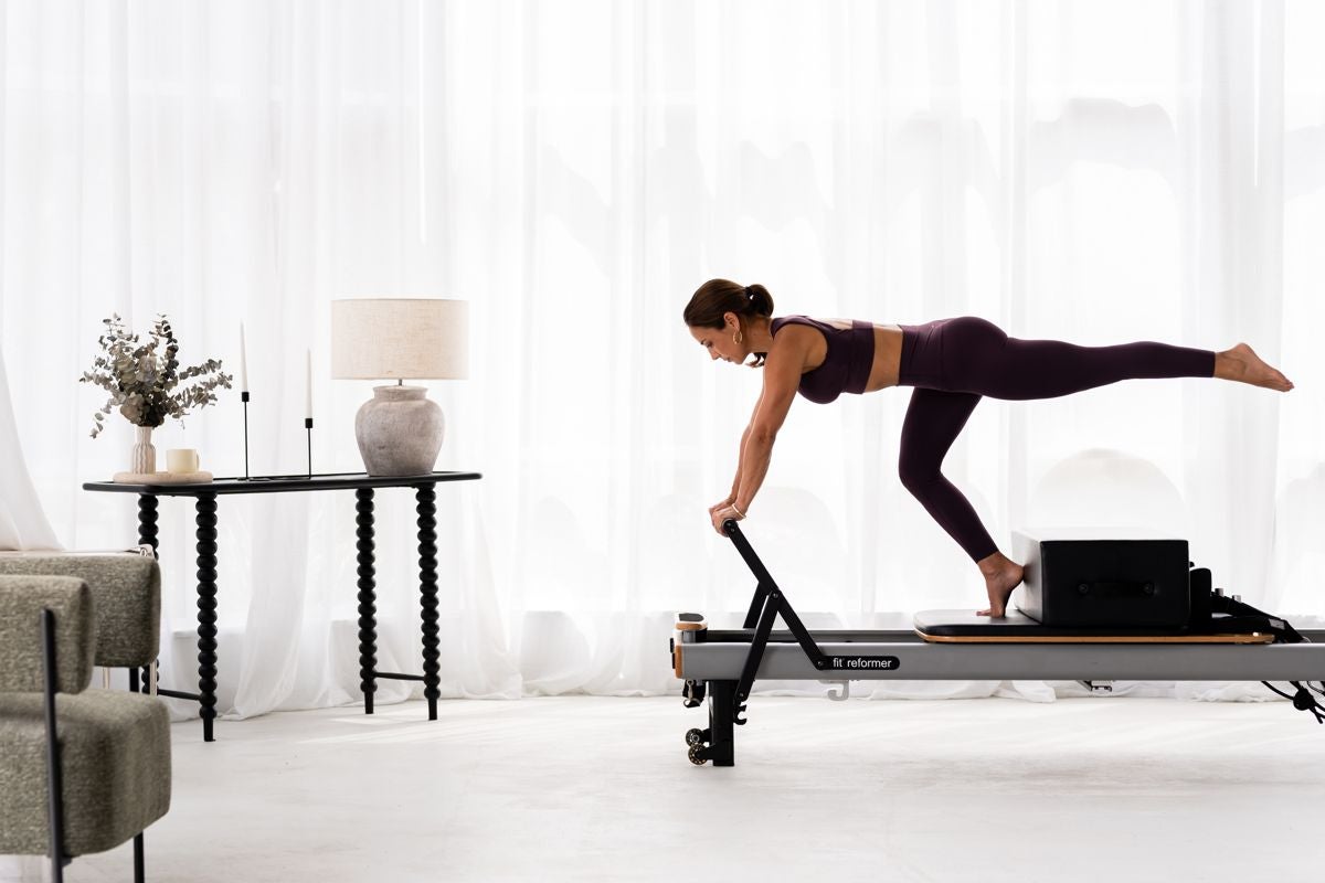 A guest training on a reformer at home