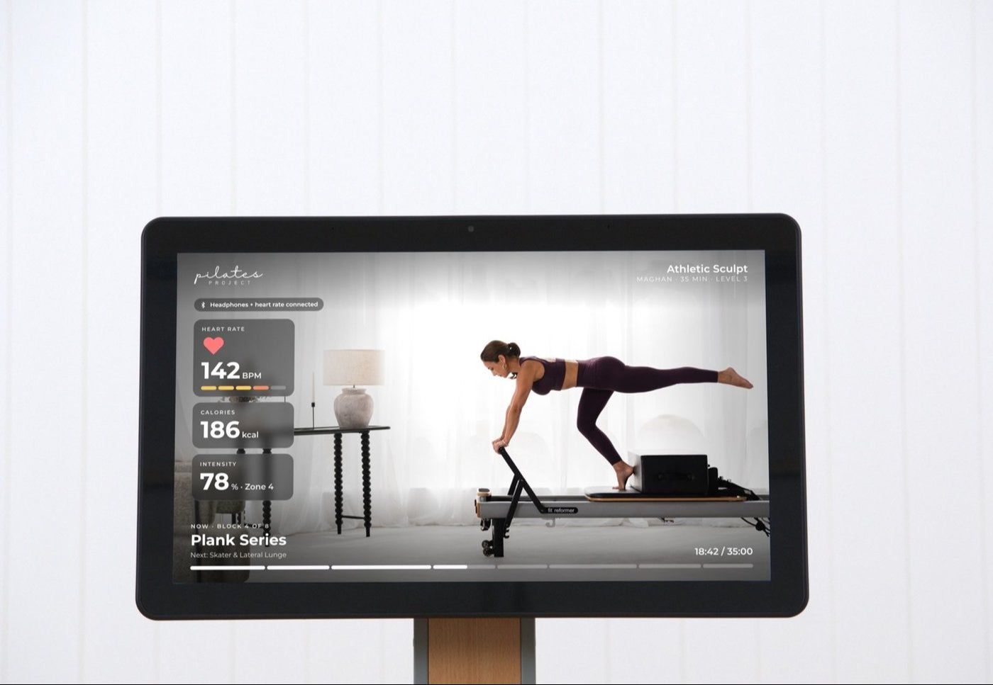 The StudioConnect kiosk showing a live class with heart rate, calories and intensity