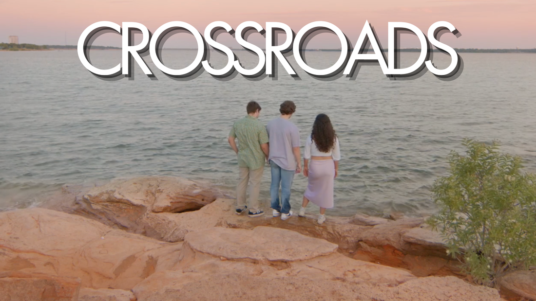 Crossroads title card: three friends on red rocks above a lake